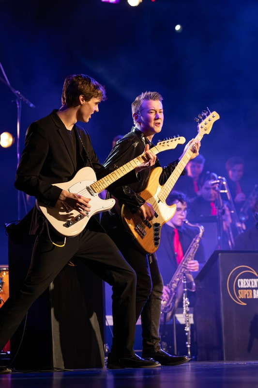 Young musicians performing together on stage